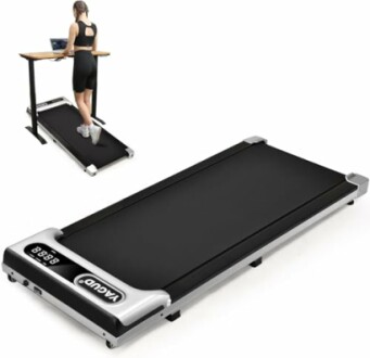 Foldable treadmill with a person using a laptop on a desk.