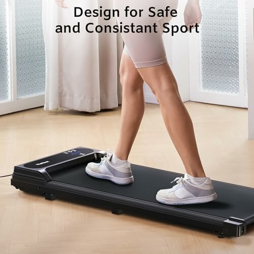 Person walking on foldable treadmill indoors
