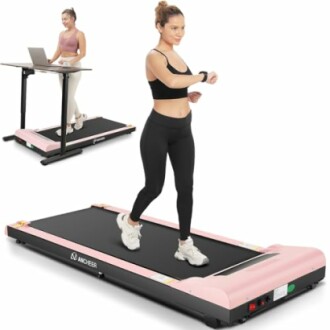 Woman using a compact treadmill with a desk setup.
